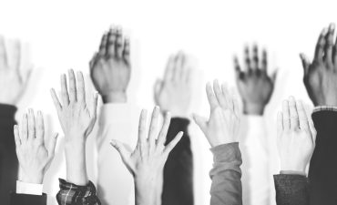 multiethnic-group-hands-raised